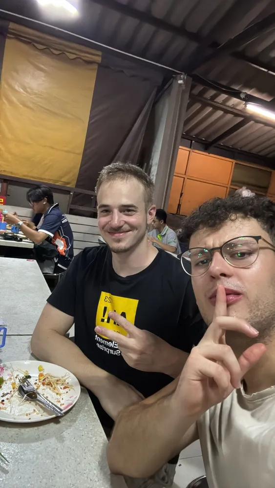 Two friends posing together over a meal