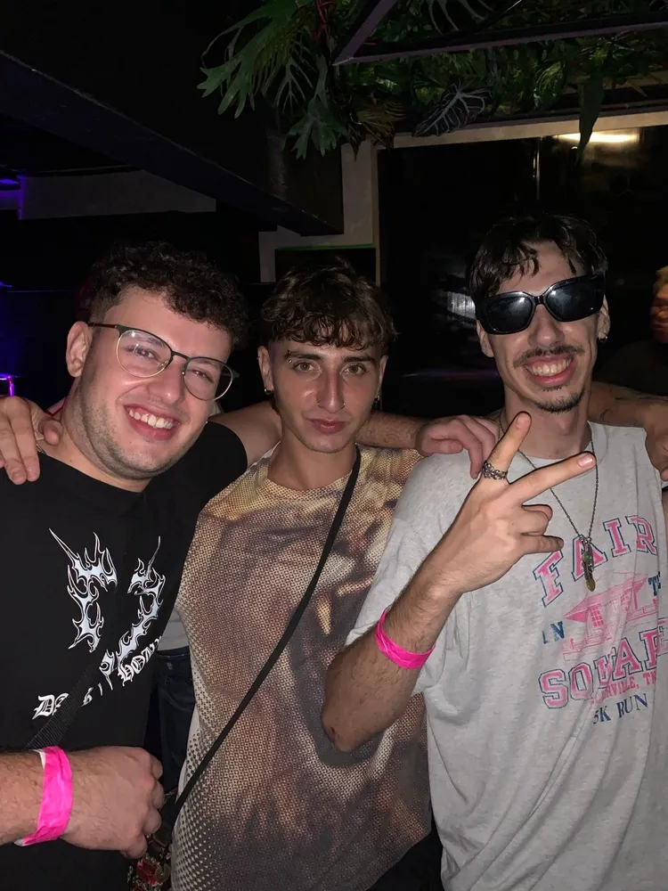 Three friends posing together on a night out