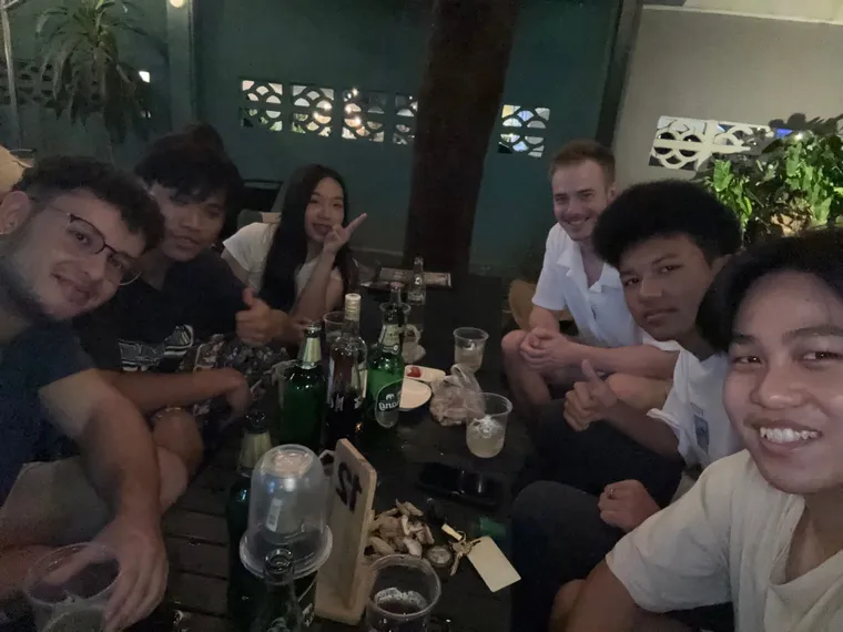 Friends gathered around a table outdoors