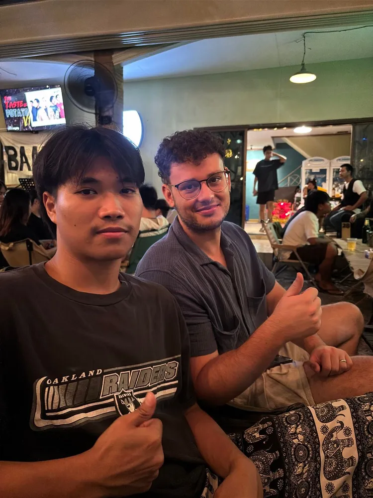 Two friends seated together indoors