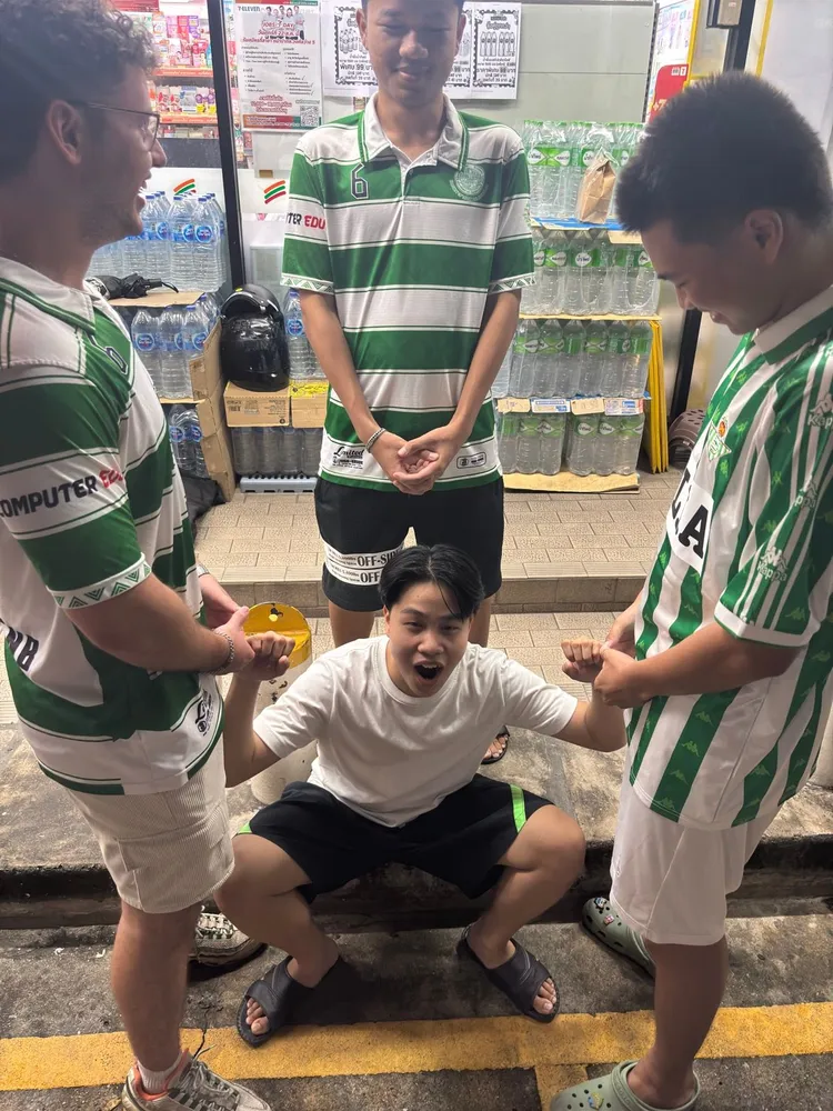 Friends in green football shirts posing together