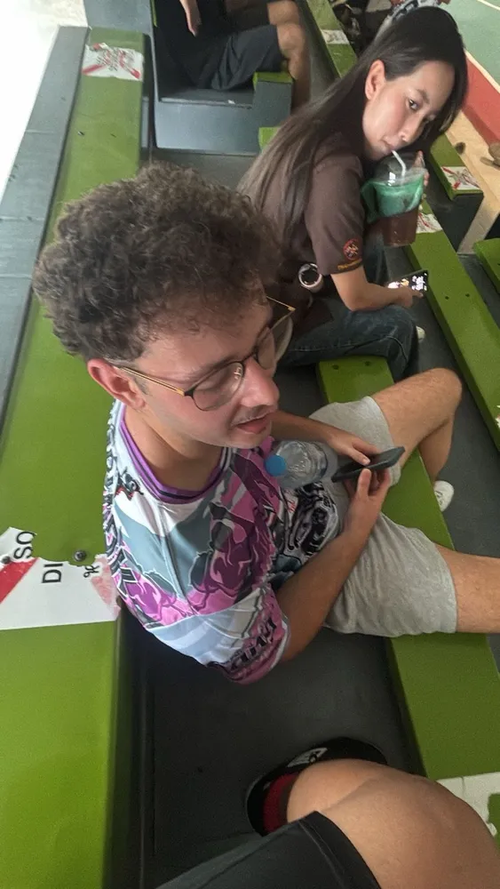 Friends sitting together in football shirts